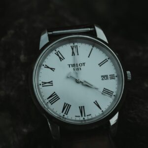 Close-up of a classic wristwatch featuring Roman numerals and a polished design.