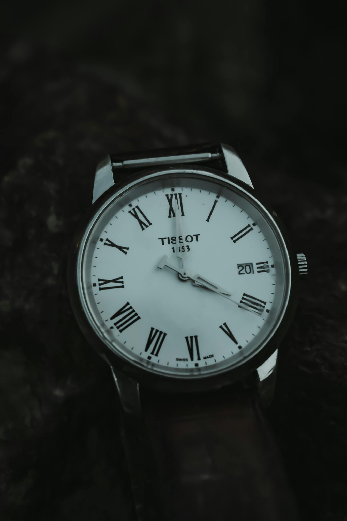 Close-up of a classic wristwatch featuring Roman numerals and a polished design.
