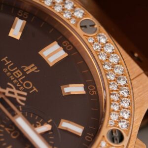 Close-up of an elegant luxury watch featuring a diamond-studded bezel and sleek design.