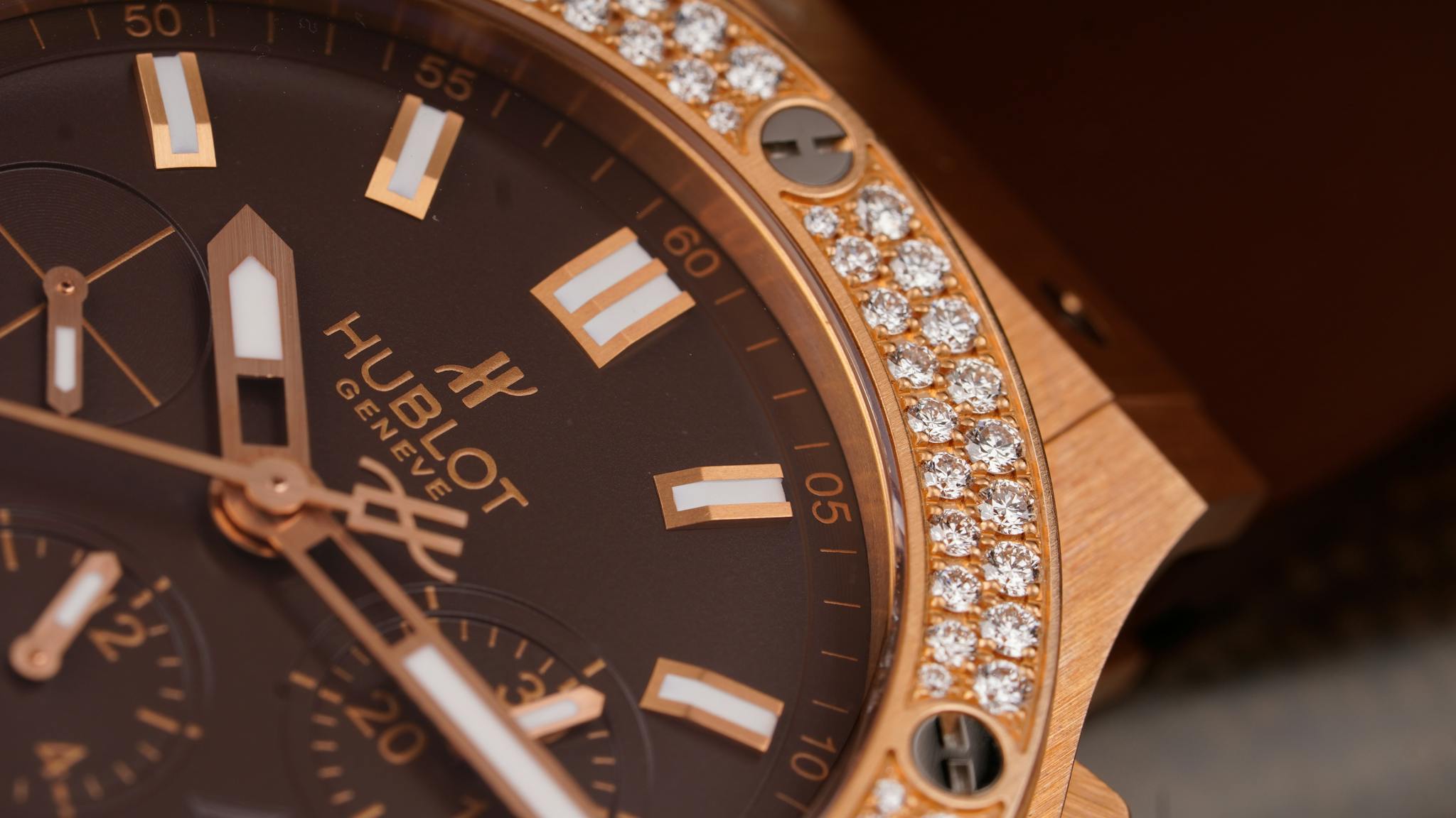 Close-up of an elegant luxury watch featuring a diamond-studded bezel and sleek design.