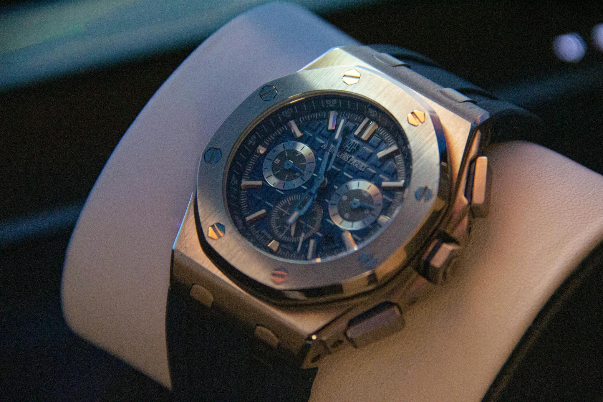 Close-up shot of a luxury chronograph watch with steel case and leather strap.