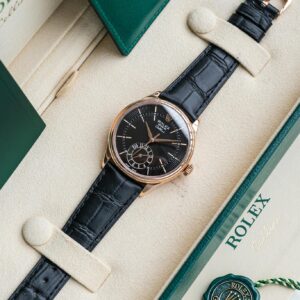 Elegant Rolex watch displayed in a luxury box with green accents and leather strap.